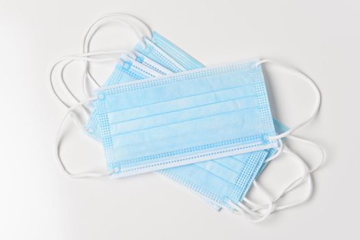 High angle view of a group of Surgical Masks on white. 