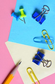 Back to School Concept: Overhead flat lay arrangement of school supplies on a pink background.