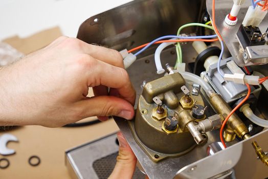 Repair of coffee machine at home. Spare parts for the espresso machine. Repair of kitchen appliances service concept