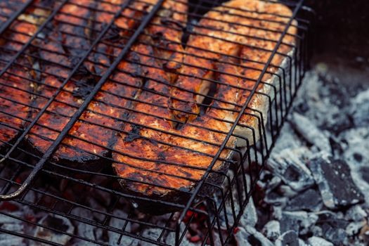 cooking fish outdoors barbecue close-up charcoal meal. High quality photo