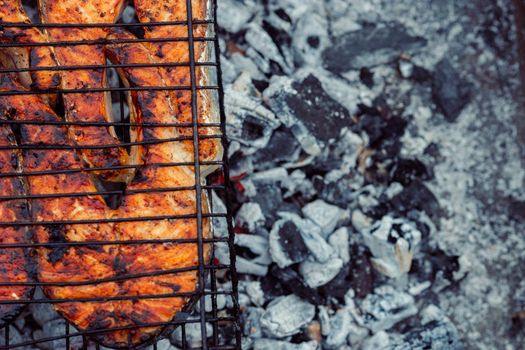 cooking fish outdoors barbecue close-up charcoal meal. High quality photo