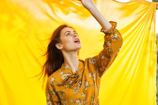 cheerful woman gesturing with her hands yellow background. High quality photo
