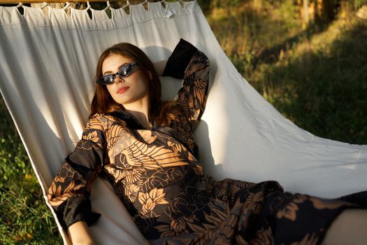 woman lies on a hammock outdoors leisure summer fashion. High quality photo