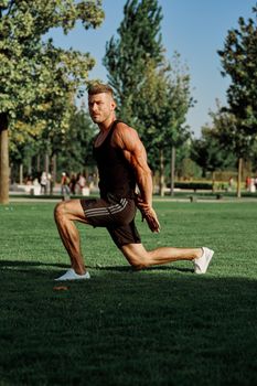 sports man in the park exercise fitness cardio. High quality photo