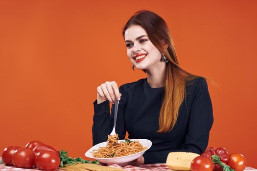 woman sitting at the table with food eating spaghetti. High quality photo