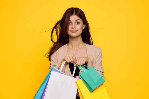 cheerful woman multicolored packs emotions shopping fashion studio model. High quality photo