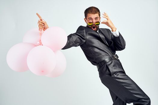 business man pink balloons office party light background. High quality photo