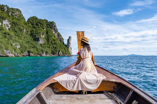 Maya Bay Koh Phi Phi Thailand, Turquoise clear water Thailand Koh Pi Pi, Scenic aerial view of Koh Phi Phi Island in Thailand. Asian woman mid age with hat in longtail boat