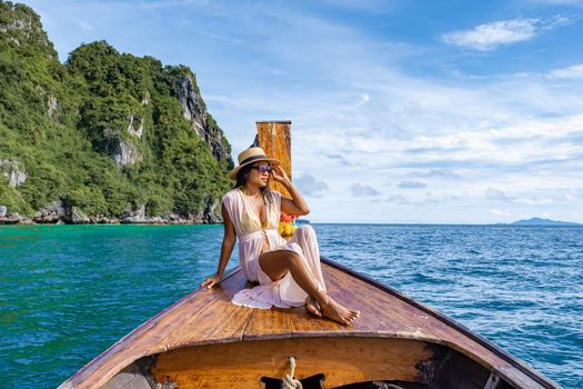 Maya Bay Koh Phi Phi Thailand, Turquoise clear water Thailand Koh Pi Pi, Scenic aerial view of Koh Phi Phi Island in Thailand. Asian woman mid age with hat in longtail boat