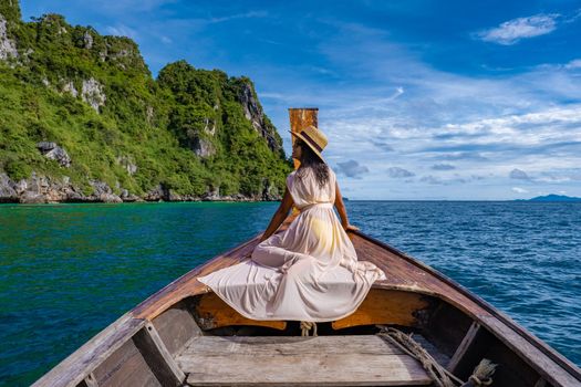 Maya Bay Koh Phi Phi Thailand, Turquoise clear water Thailand Koh Pi Pi, Scenic aerial view of Koh Phi Phi Island in Thailand. Asian woman mid age with hat in longtail boat