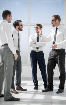 in full growth.employees discussing their ideas standing in the office lobby . business concept