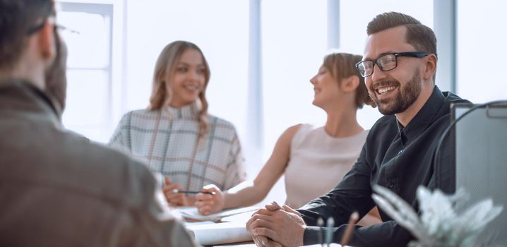 smiling businessman at a working meeting in the office. photo with copy space