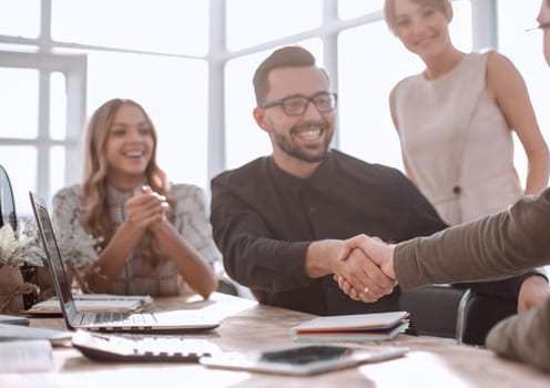 happy business colleagues shaking hands with each other. success concept