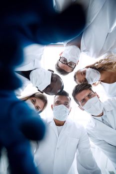 Surgeons in operating theatre looking down at patient, personal perspective