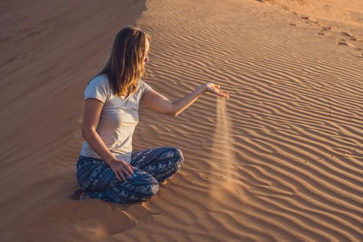 young woman in rad sandy desert at sunset or dawn