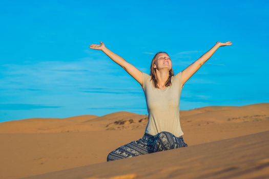 young woman in rad sandy desert at sunset or dawn