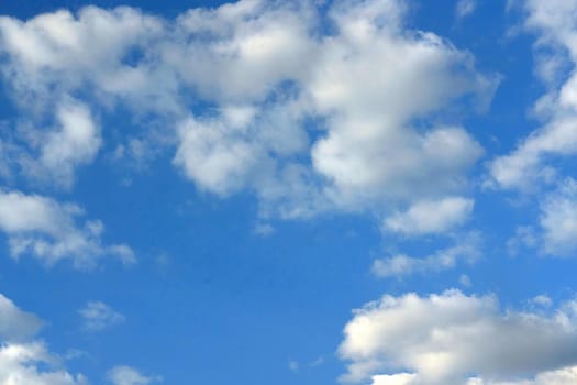 White clouds in the blue sky, background of white clouds in the sky. Weather phenomenon in the atmosphere