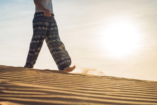 young woman in rad sandy desert at sunset or dawn