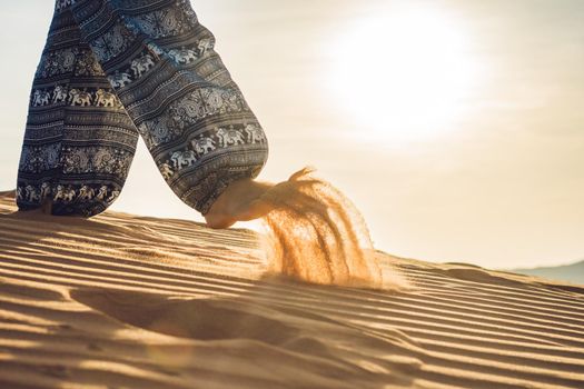 young woman in rad sandy desert at sunset or dawn