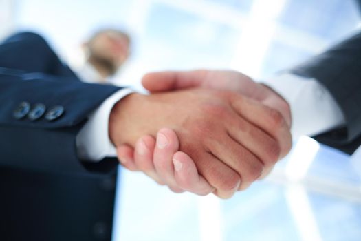 bottom view .handshake businessmen with a business partner