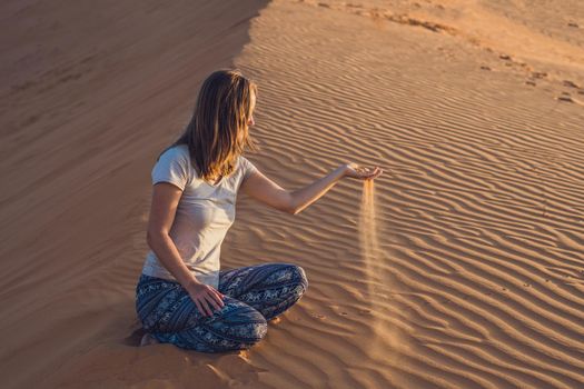 young woman in rad sandy desert at sunset or dawn