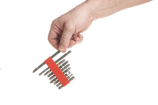 Hand holds a set of bits for a screwdriver on a white background, a template for designers.