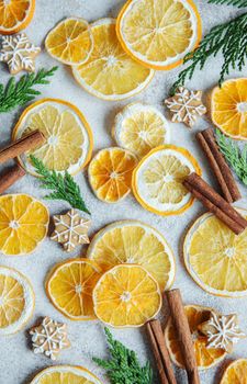 Arrangement of dry oranges, gingerbread cookies and cinnamon sticks. Christmas holiday background