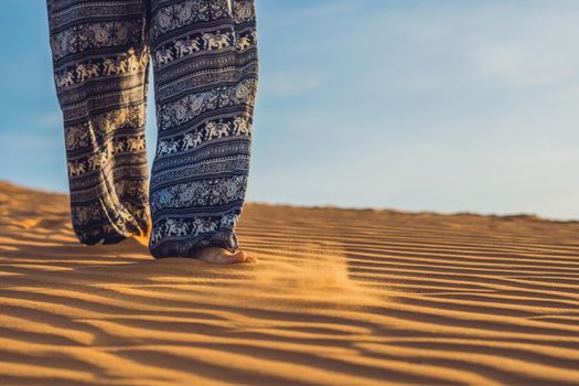 young woman in rad sandy desert at sunset or dawn