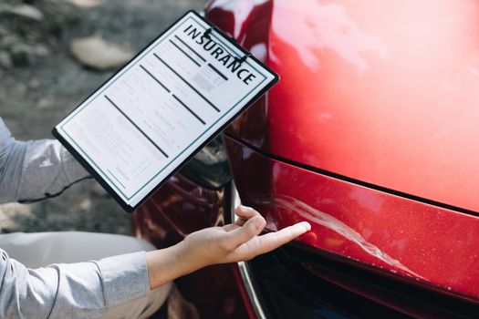 Man agent checking of the damaged car and examines it, Traffic Accident and insurance concept