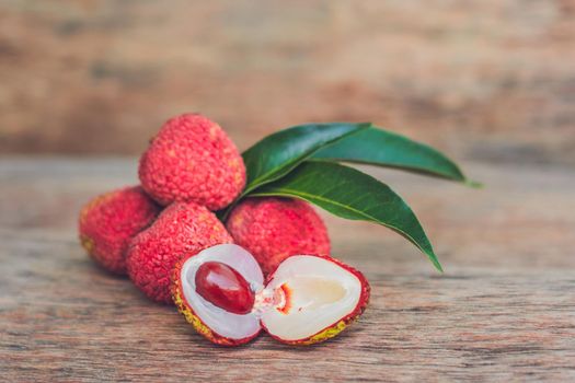 Fresh litchi fruit on an old wooden background.