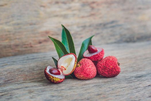 Fresh litchi fruit on an old wooden background.