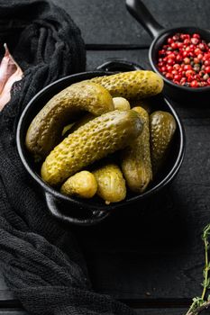 Bavarian gherkins set, on black wooden table background