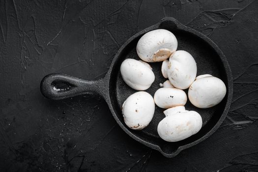 Mushroom champignon set, on black stone background, top view flat lay
