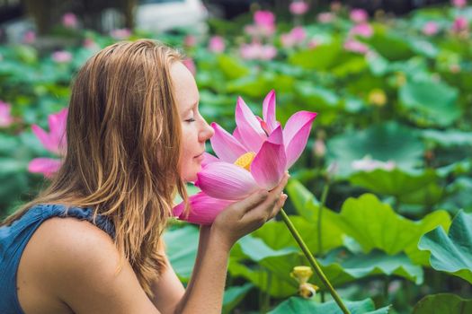 picture of beautiful woman Red-haired with lotus flower in hand.