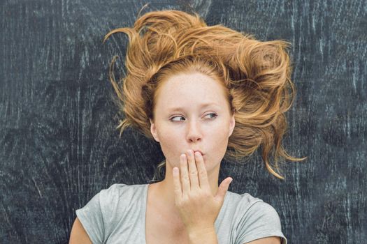 Top view of a young woman with space for text and symbols on the old wooden background. Concept for confusion, brainstorming and choice.