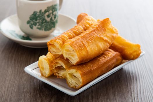 Youtiao (Chinese fried breadstick). Long golden brown deep fried dough strip.