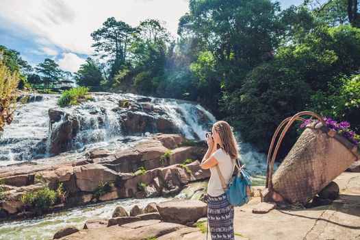 Young woman on the background of Beautiful Camly waterfall In Da Lat city,