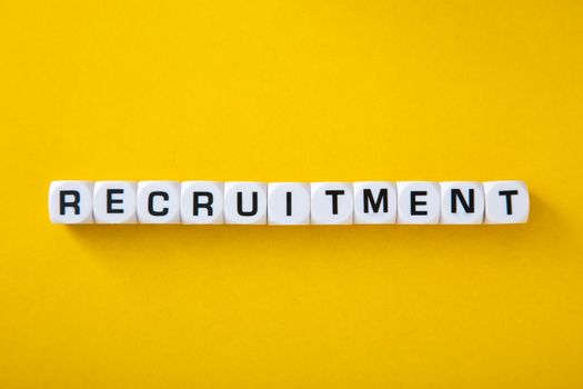 White block with word Recruitment" on yellow background