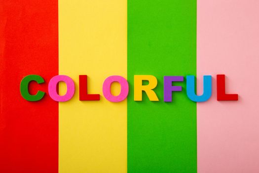 Bright multicolored alphabet with colorful wording background. Flat Lay