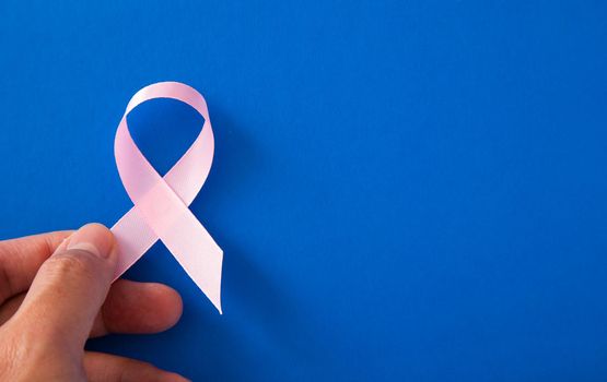 Breast Cancer concept : Woman hands and supporting Pink ribbon symbol of breast cancer