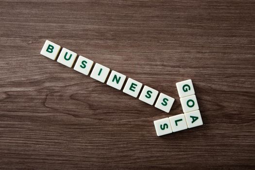 Words of business goals concepts collected in crossword with wooden cubes