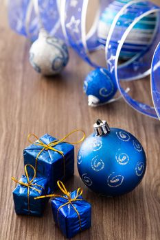 Christmas composition. Christmas gifts, decorations on wooden background. Copy space