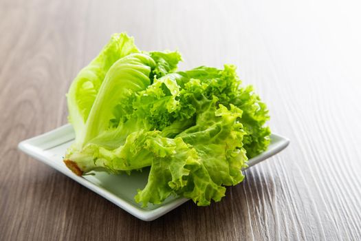 Fresh lettuce salad on a wooden table