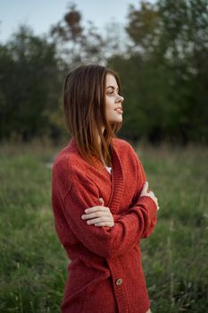 pretty woman in red sweater outdoors walk leisure. High quality photo