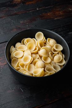 Semolina pasta dried, on dark wooden background