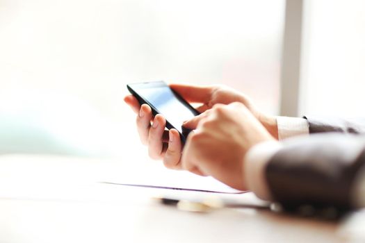 Young businessman working with modern devices, mobile phone.