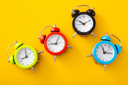 Alarm clock on isolated yellow background.