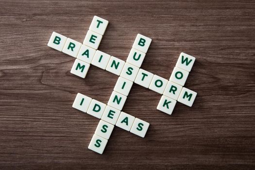 Words of business concepts collected in crossword with wooden cubes