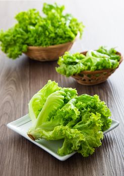 Fresh lettuce salad on a wooden table