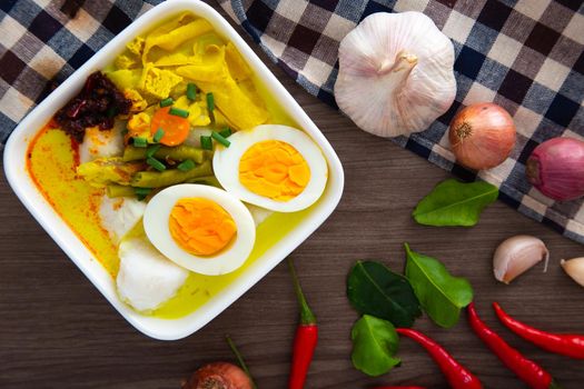 “ Lontong Ketupat / Lontong Kupat ” or Rice Cake and coconut gravy with tumeric, chilli, and vegetables. A famous Malaysian and Indonesia food.